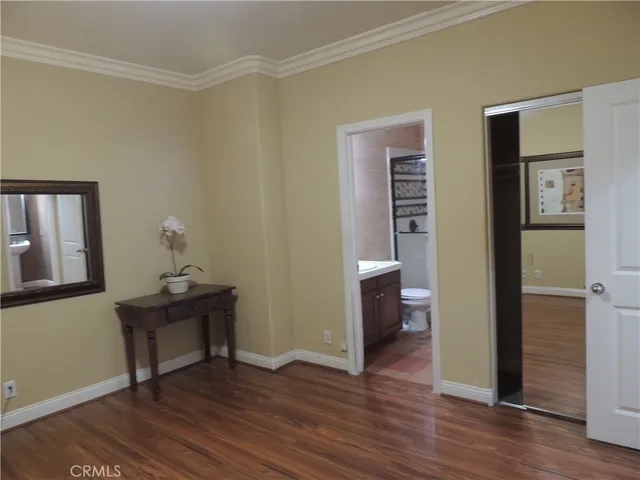a view of a room with wooden floor cabinet and windows