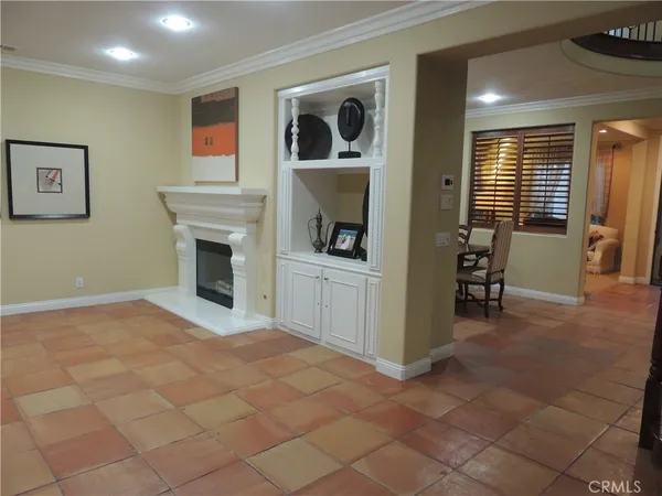 a view of an empty room with window and fireplace
