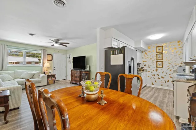a dining room with furniture a large window and a fireplace