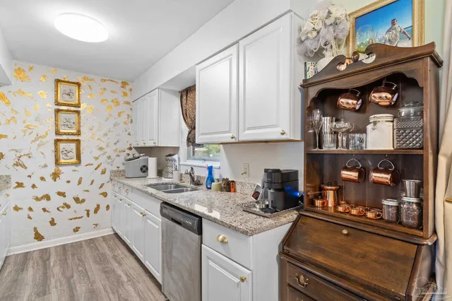 a kitchen with stainless steel appliances granite countertop a sink stove and cabinets