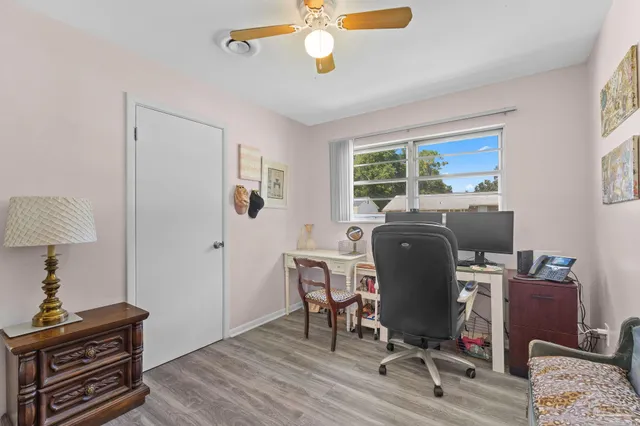 a view of a workspace with furniture and a window