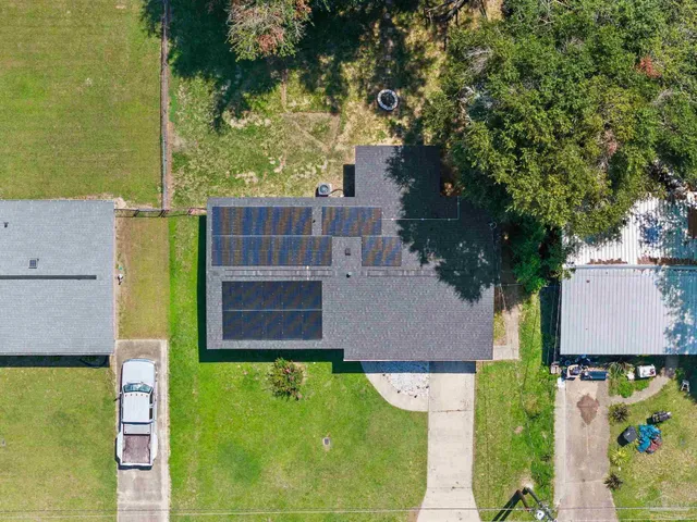 an aerial view of a house with swimming pool garden and patio