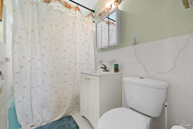 a white toilet sitting next to a bathroom sink