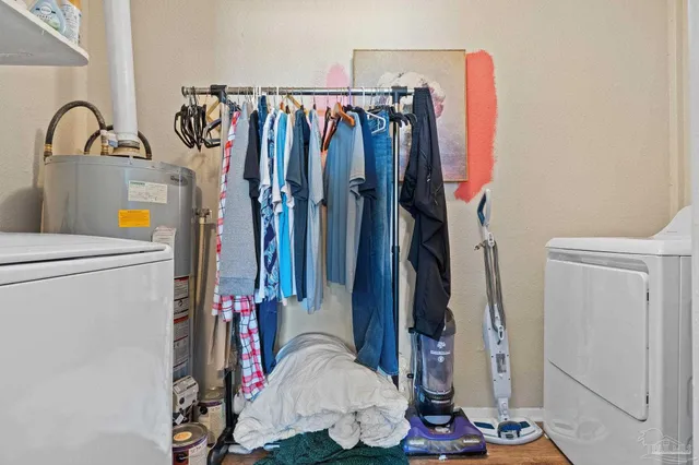 a view of walk in closet with clothes