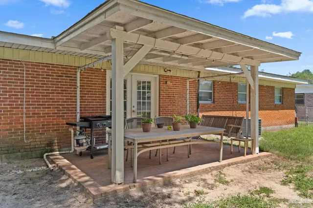 a view of a patio with couches chairs and potted plants
