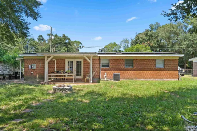 a view of a house with a yard and sitting area