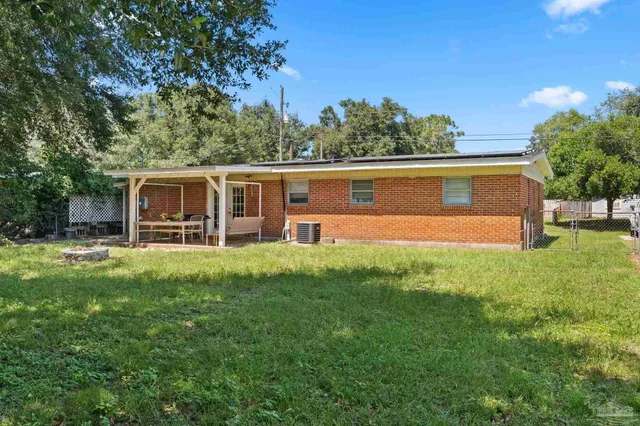 a view of house with backyard
