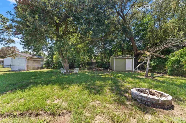 a backyard of a house with a garden and plants
