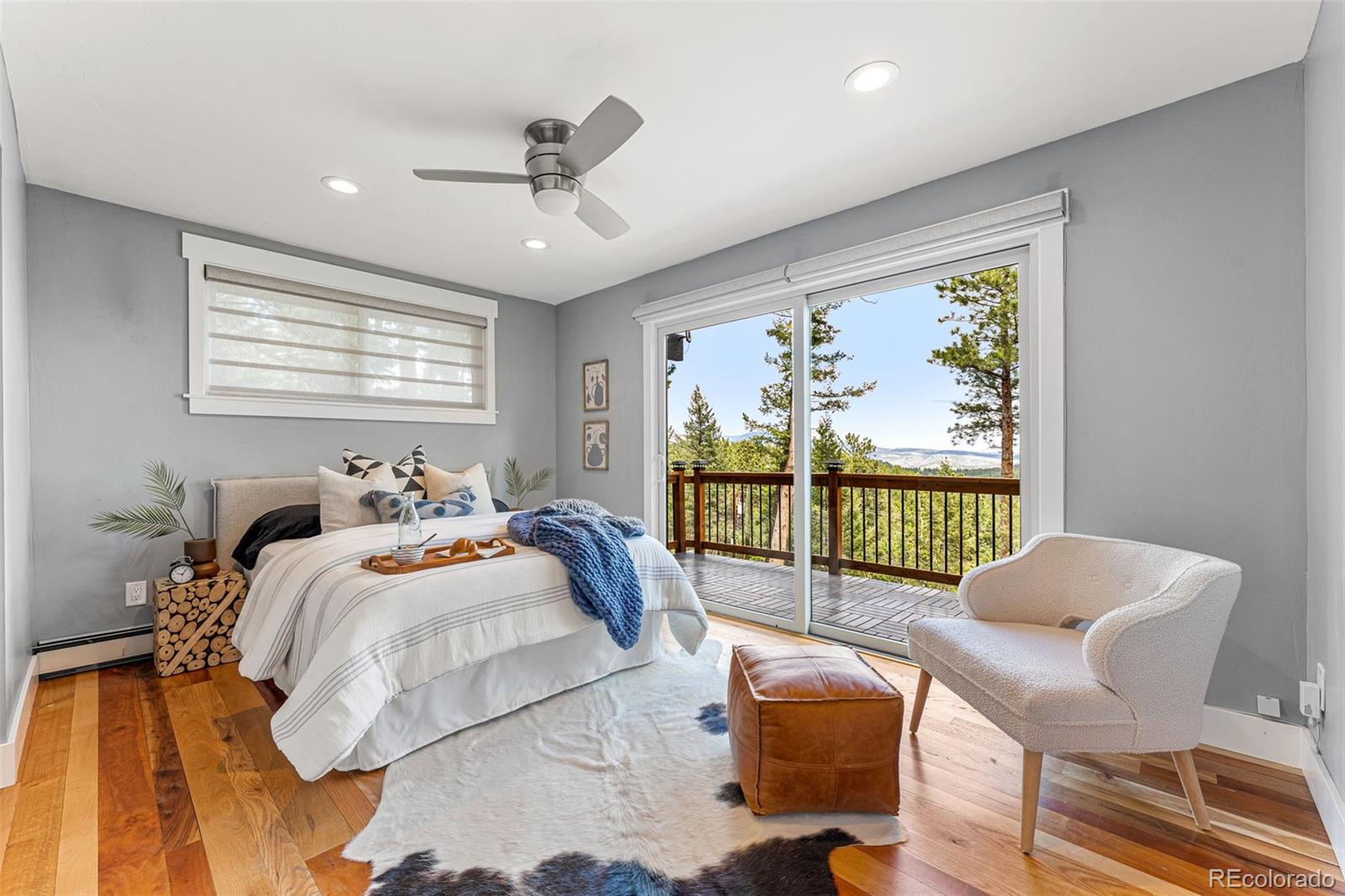 30242 Pine Crest Drive Evergreen, CO 80439 - Photo 11 of 28 a bed room with a bed and a chair