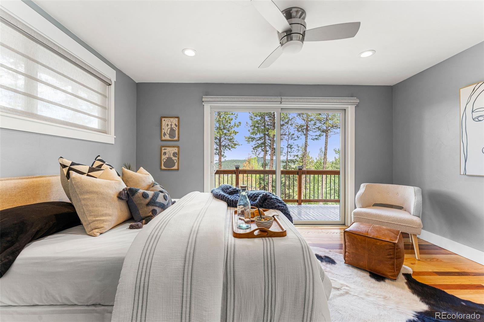 30242 Pine Crest Drive Evergreen, CO 80439 - Photo 12 of 28 a bedroom with bed and a large window