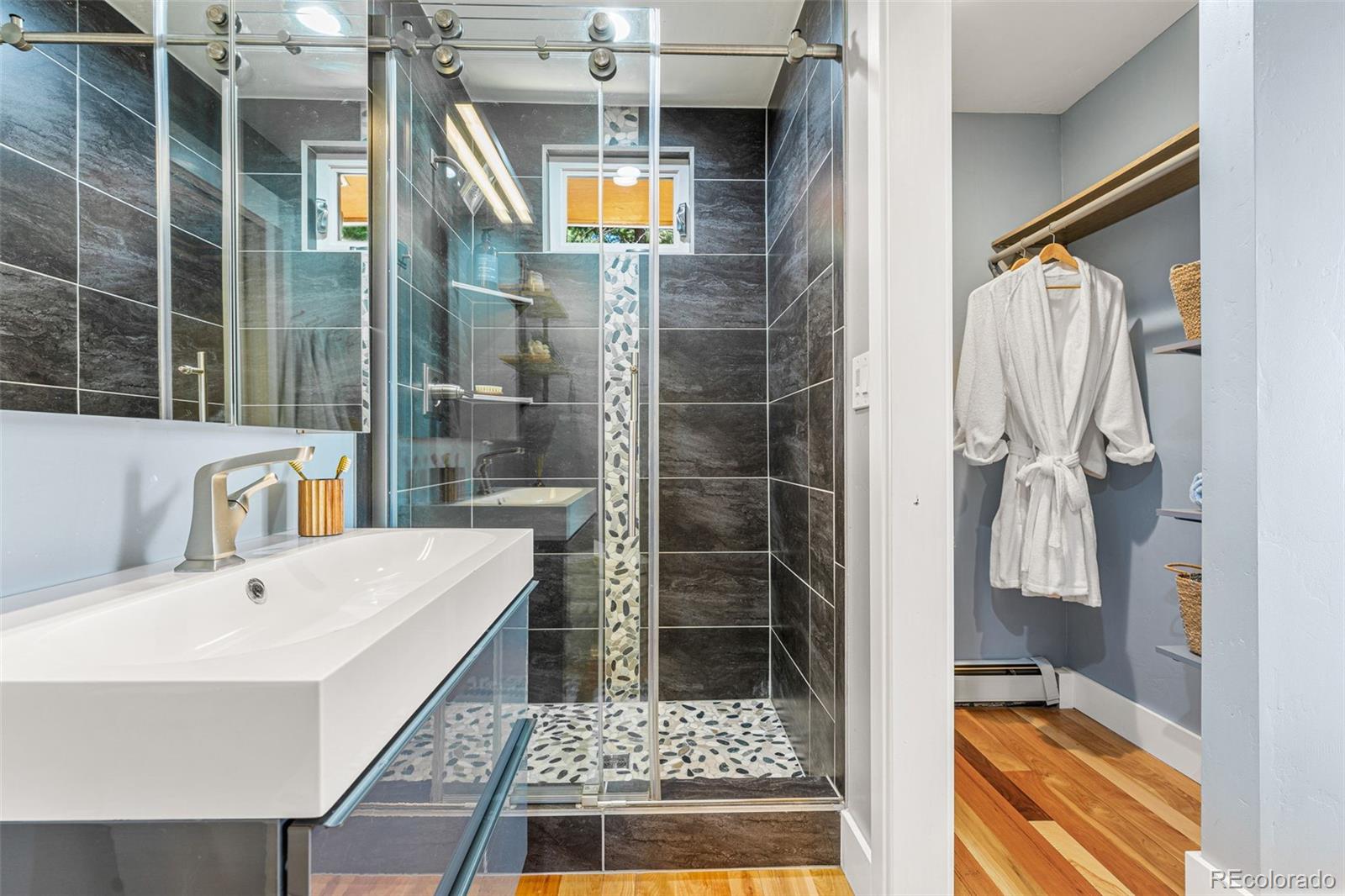 30242 Pine Crest Drive Evergreen, CO 80439 - Photo 15 of 28 a bathroom with a tub a sink and a shower