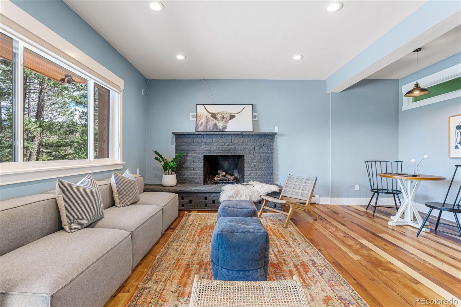 30242 Pine Crest Drive Evergreen, CO 80439 - Photo 19 of 28 a living room with furniture and a fireplace