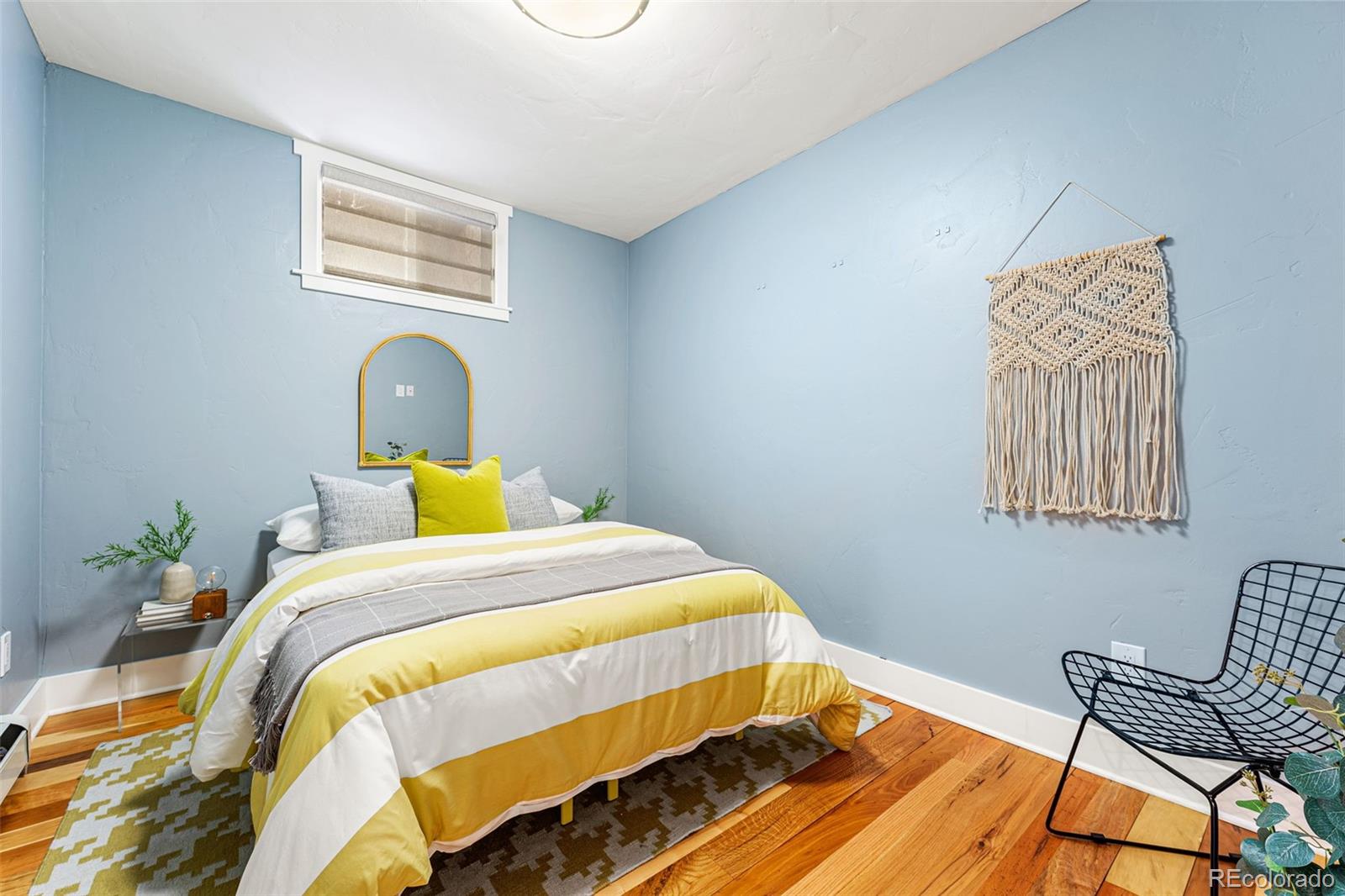 30242 Pine Crest Drive Evergreen, CO 80439 - Photo 21 of 28 a bed sitting in a bedroom next to a window