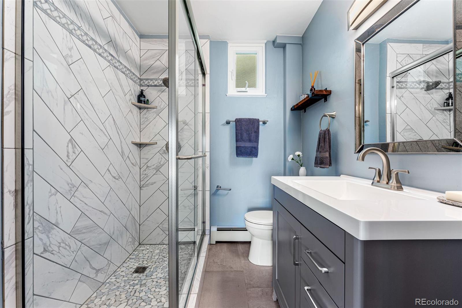 30242 Pine Crest Drive Evergreen, CO 80439 - Photo 22 of 28 a bathroom with a sink toilet and shower
