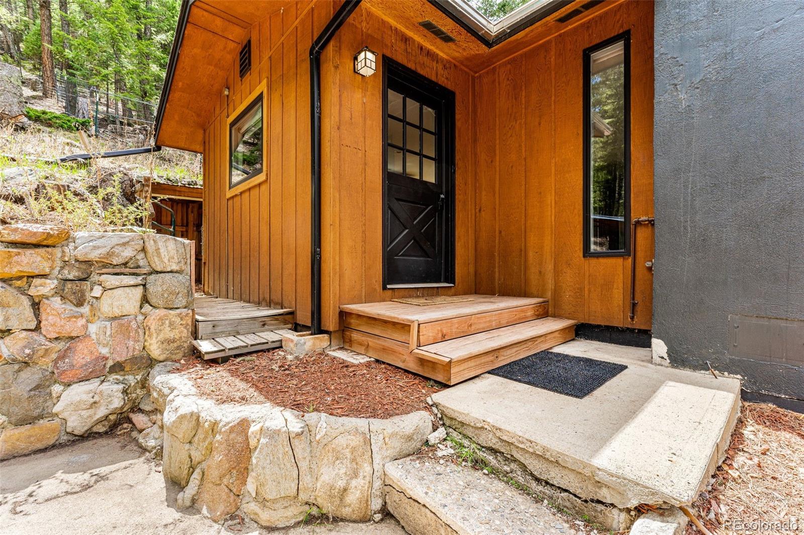 30242 Pine Crest Drive Evergreen, CO 80439 - Photo 3 of 28 a bedroom with a bed and a window