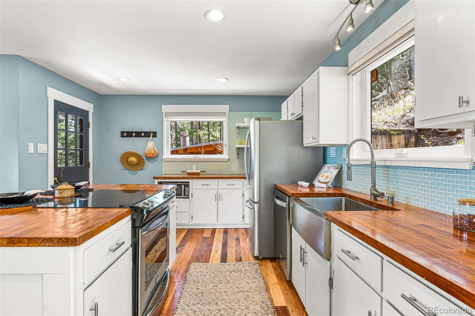 30242 Pine Crest Drive Evergreen, CO 80439 - Photo 5 of 28 a kitchen with a sink stove and cabinets
