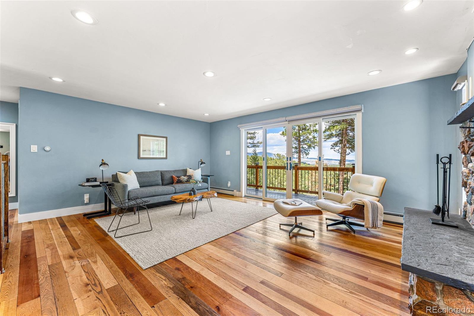 30242 Pine Crest Drive Evergreen, CO 80439 - Photo 6 of 28 a living room with furniture and a wooden floor