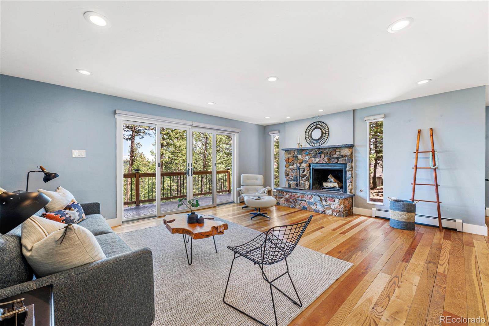 30242 Pine Crest Drive Evergreen, CO 80439 - Photo 7 of 28 a living room with fireplace furniture and a large window