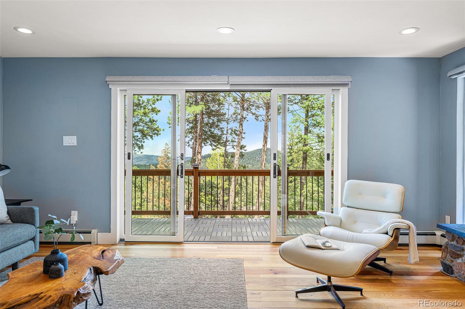 30242 Pine Crest Drive Evergreen, CO 80439 - Photo 8 of 28 a living room with furniture and a large window