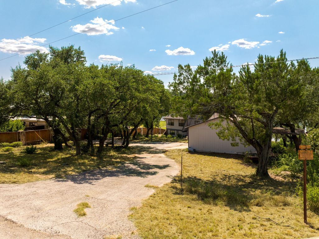 19625 Lakehurst Loop Spicewood, TX 78669 - Photo 1 of 25 a view of a backyard of the house