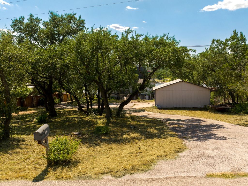 19625 Lakehurst Loop Spicewood, TX 78669 - Photo 2 of 25 a backyard of a house with a yard and outdoor seating