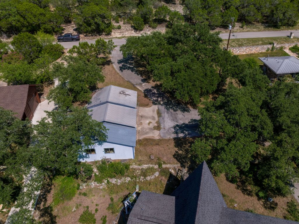19625 Lakehurst Loop Spicewood, TX 78669 - Photo 25 of 25 an aerial view of a house with outdoor space and trees all around