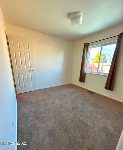 an empty room with windows and stairs