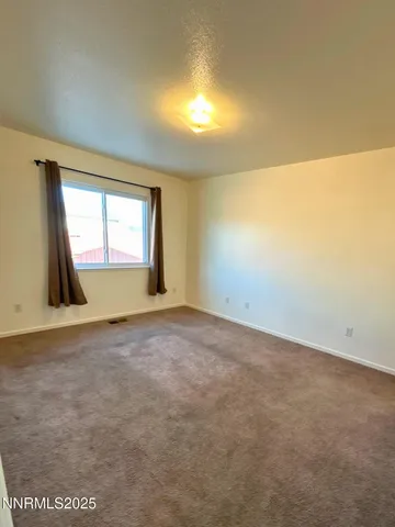 an empty room with a empty space and windows