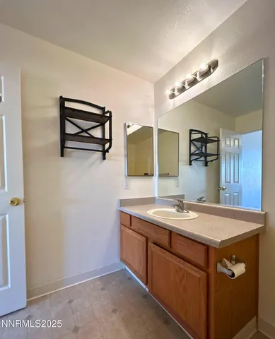 a bathroom with a sink a vanity and a mirror
