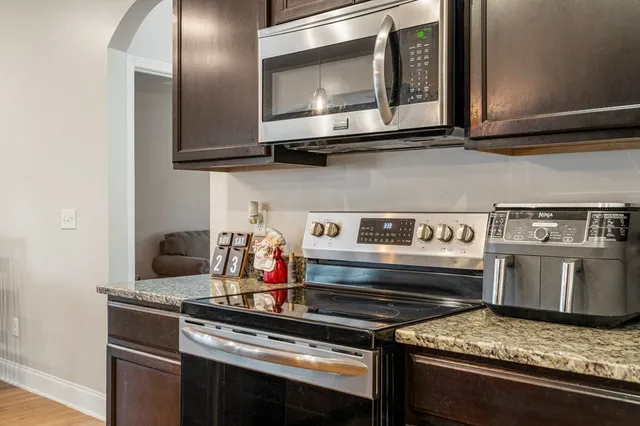 a living room with fireplace furniture and a flat screen tv