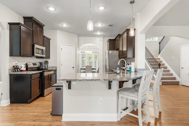 a dining room with furniture and wooden floor