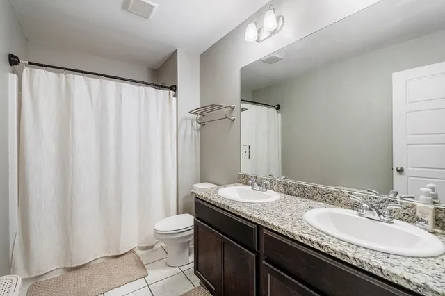 a bathroom with a granite countertop sink mirror and double