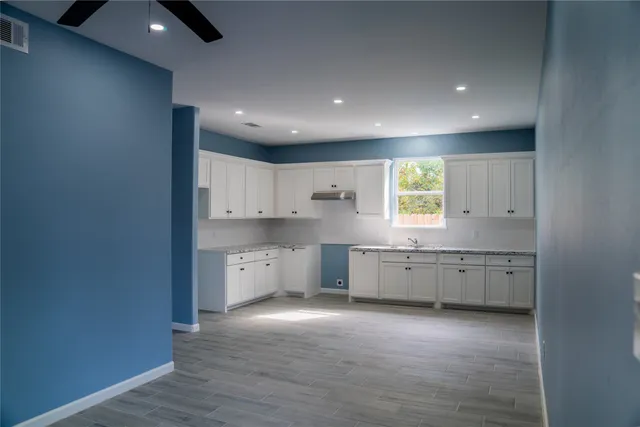 a large kitchen with a large window