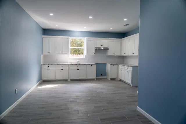 a view of kitchen with wooden floor
