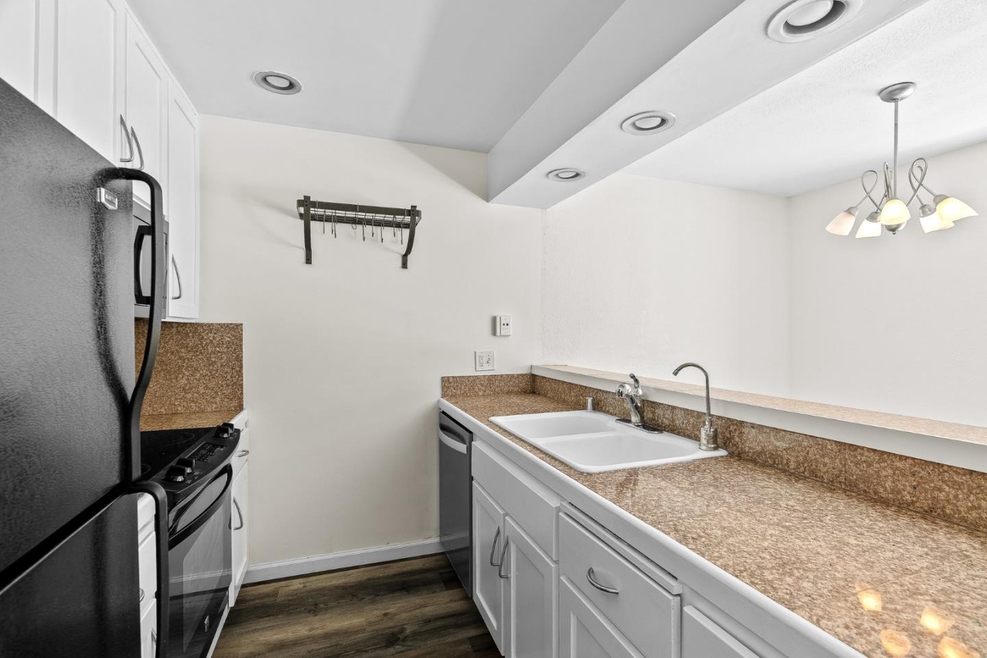 1925 46th Avenue, Unit 78 Capitola, CA 95010 - Photo 8 of 31 a bathroom with a sink a vanity and mirror