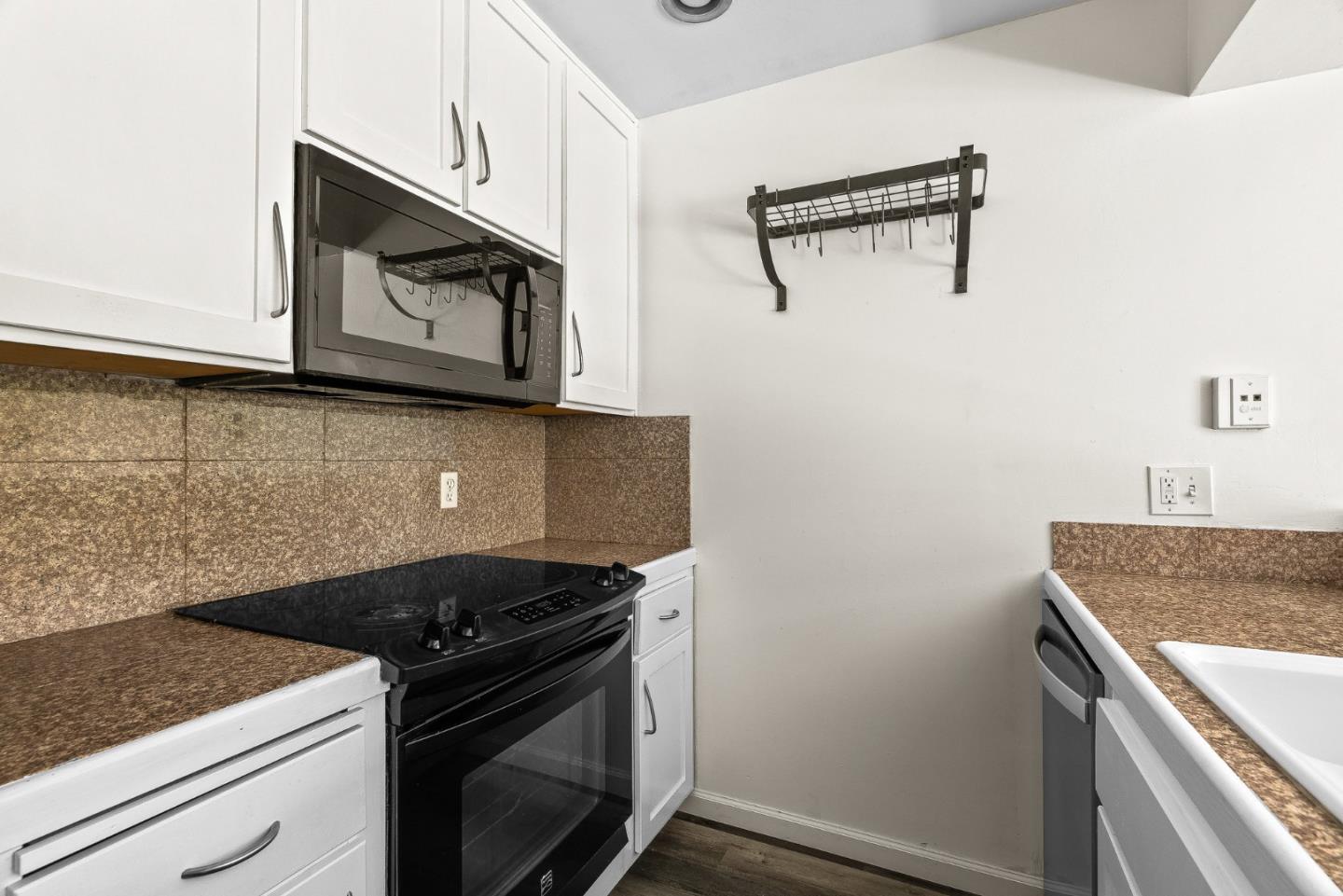 1925 46th Avenue, Unit 78 Capitola, CA 95010 - Photo 9 of 31 a kitchen with granite countertop cabinets stainless steel appliances and a counter space