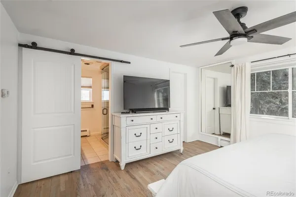 a view of a chair and table in backyard of the house