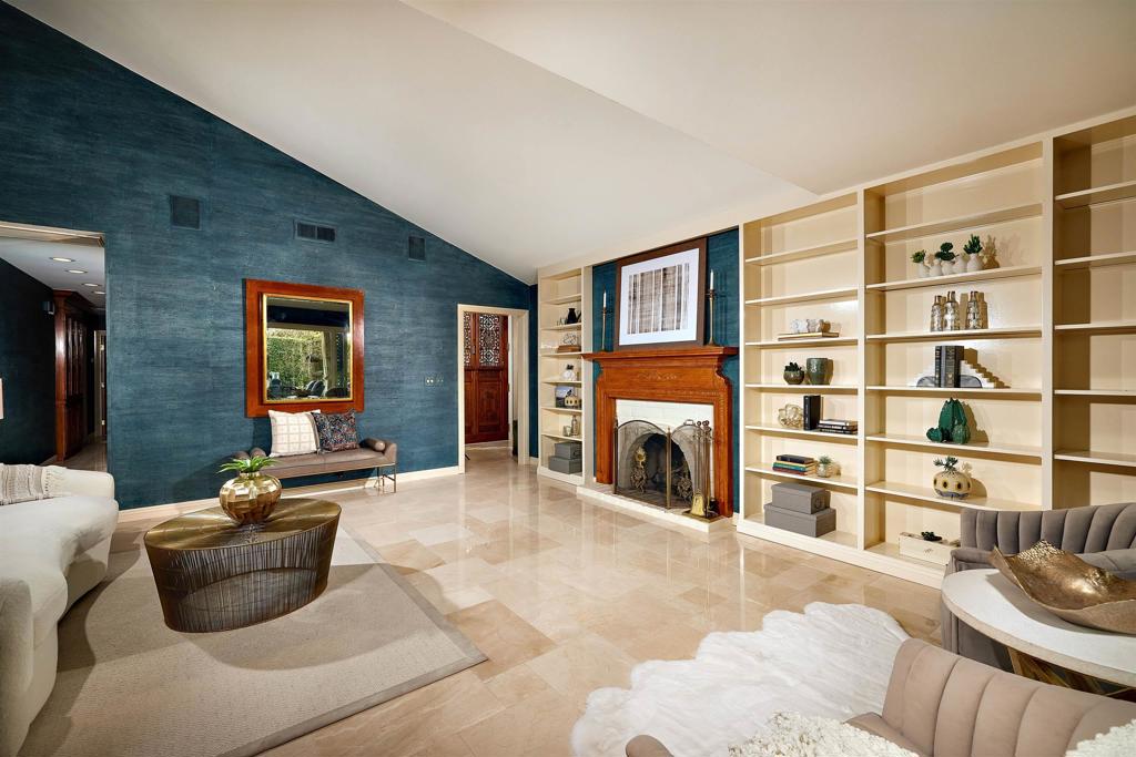 219 Calle De Sereno Encinitas, CA 92024 - Photo 23 of 43 a living room with furniture cabinets and a fireplace