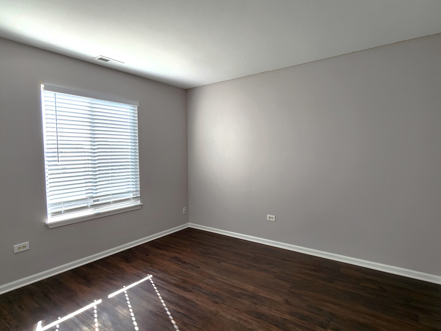 4228 Cummins Street Plano, IL 60545 - Photo 13 of 14 a view of an empty room with wooden floor and a window