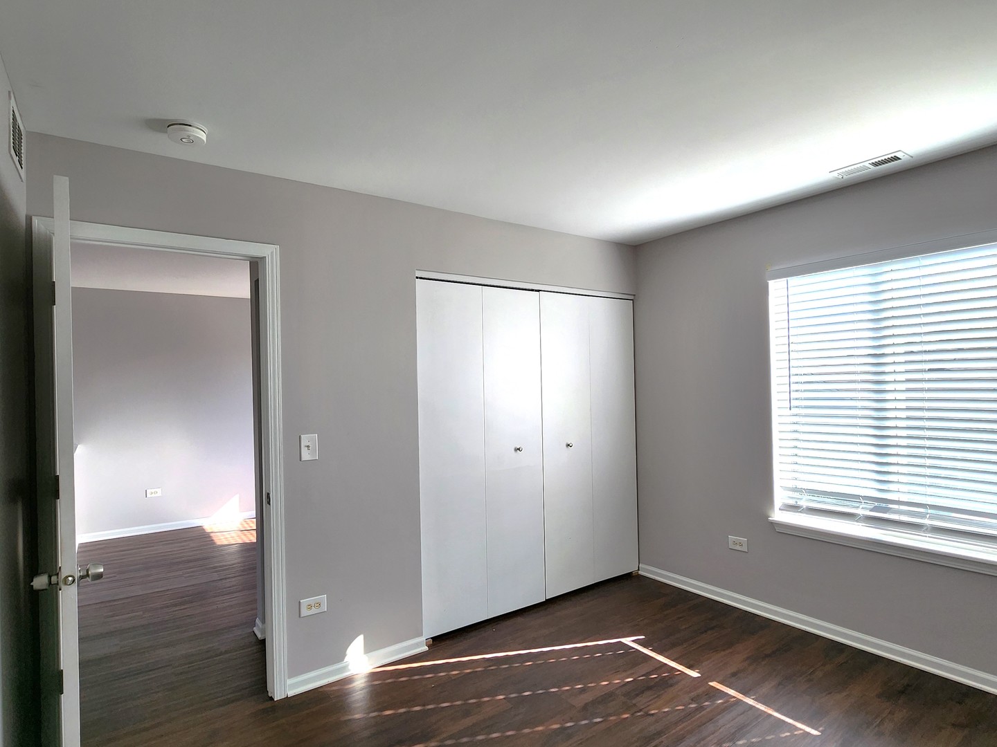 4228 Cummins Street Plano, IL 60545 - Photo 14 of 14 a view of an empty room with wooden floor and a window
