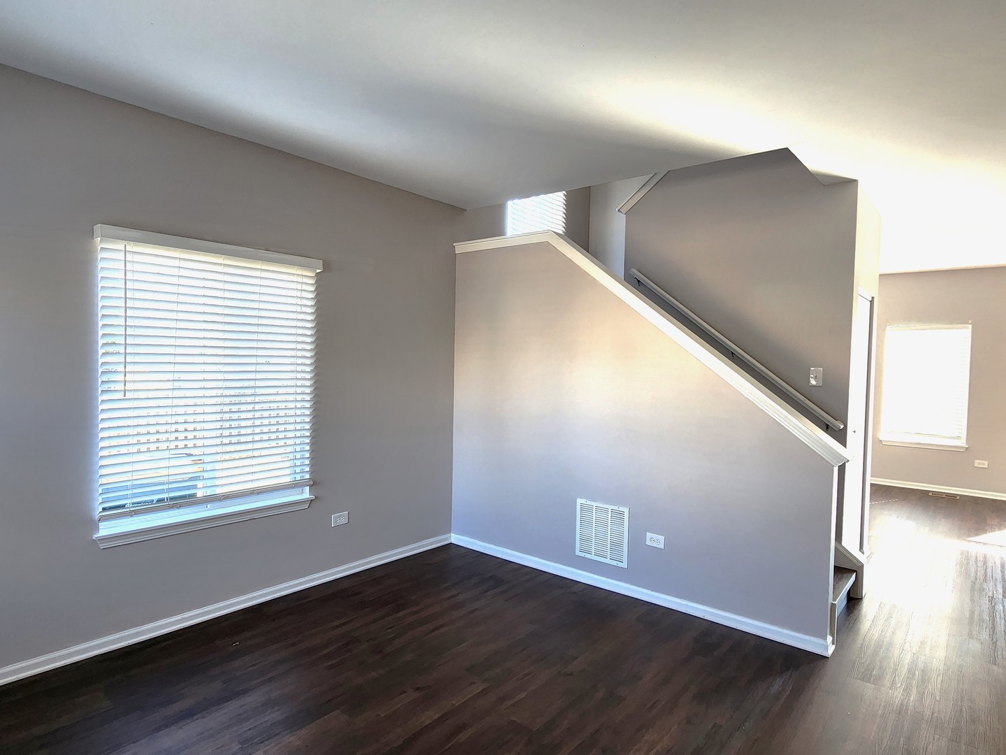 4228 Cummins Street Plano, IL 60545 - Photo 2 of 14 a view of an empty room with wooden floor and a window