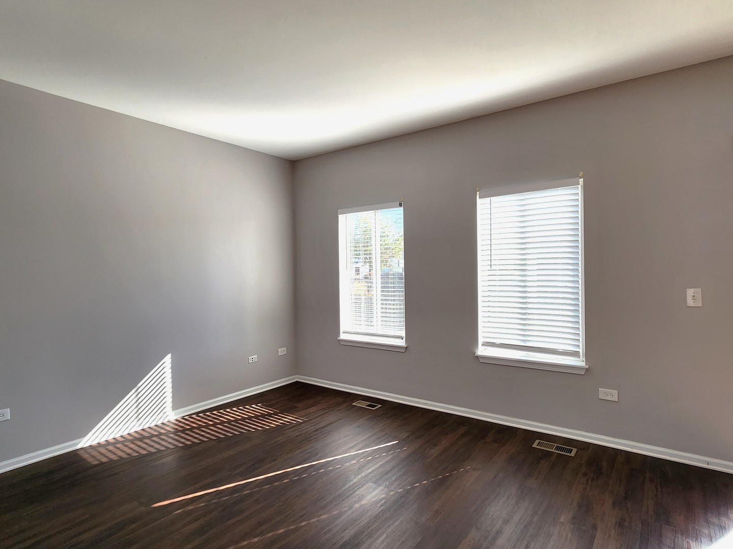 4228 Cummins Street Plano, IL 60545 - Photo 4 of 14 a view of an empty room with wooden floor and a window