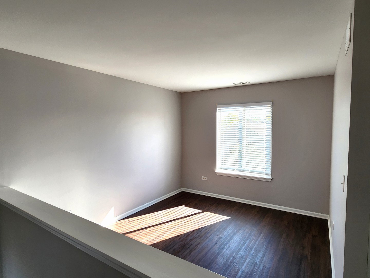 4228 Cummins Street Plano, IL 60545 - Photo 8 of 14 an empty room with wooden floor and windows