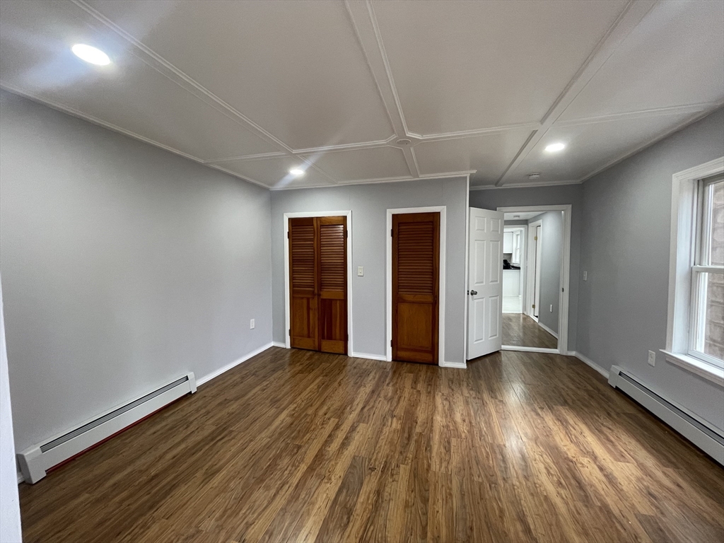 59 High Street Warren, MA 01083 - Photo 13 of 42 an empty room with wooden floor and windows