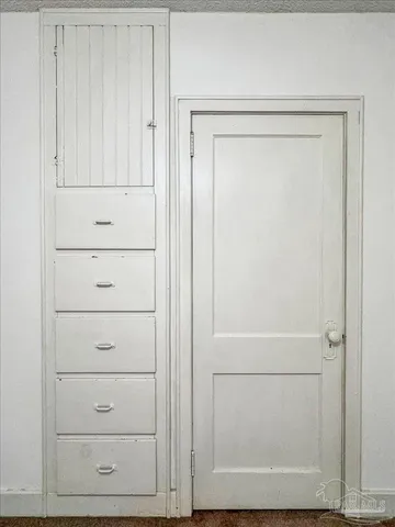 a view of an empty room with a ceiling fan