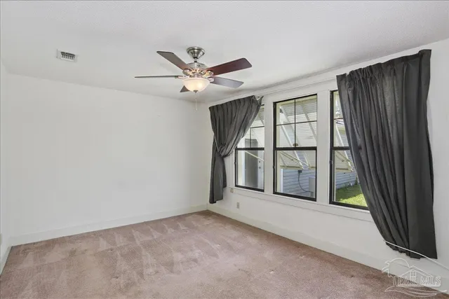 an empty room with closet and a chandelier fan