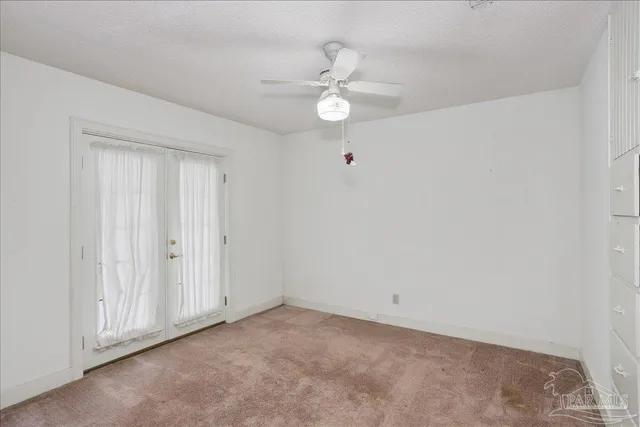 a bathroom with a granite countertop sink toilet and mirror