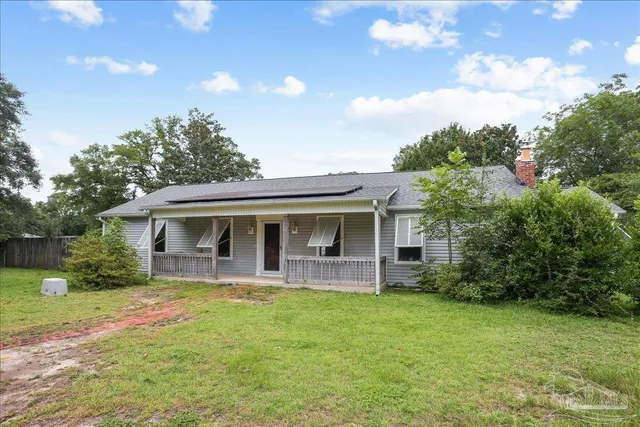 an aerial view of a house with a yard