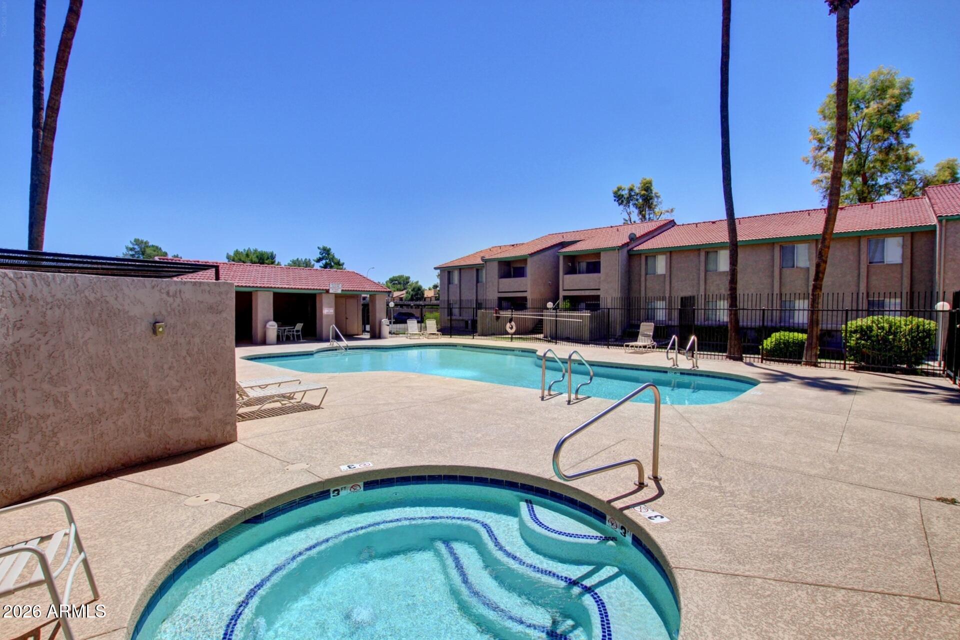 533 West Guadalupe Road, Unit 1104 Mesa, AZ 85210 - Photo 18 of 20 a view of swimming pool with a garden and plants