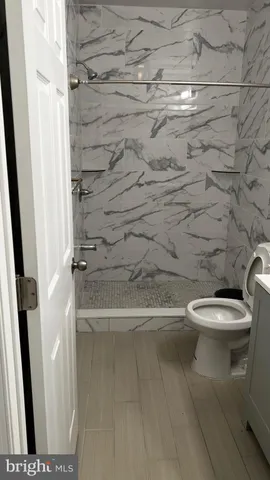 a bathroom with a toilet and a shower
